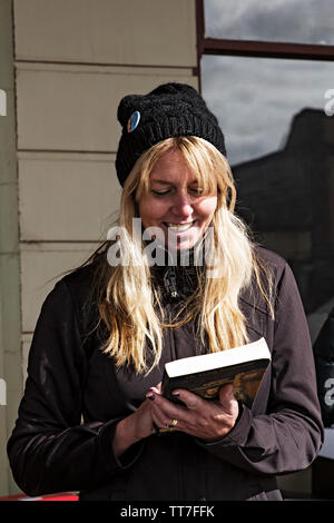 A woman reads a book at Clunes Booktown festival in the 1850`s gold mining town of Clunes in Victoria Australia. Stock Photo